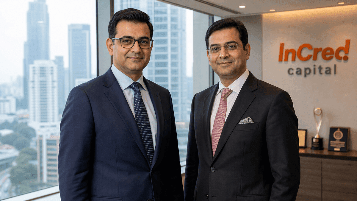 Two men in business suits stand in a modern office with a city skyline view, representing corporate leadership.